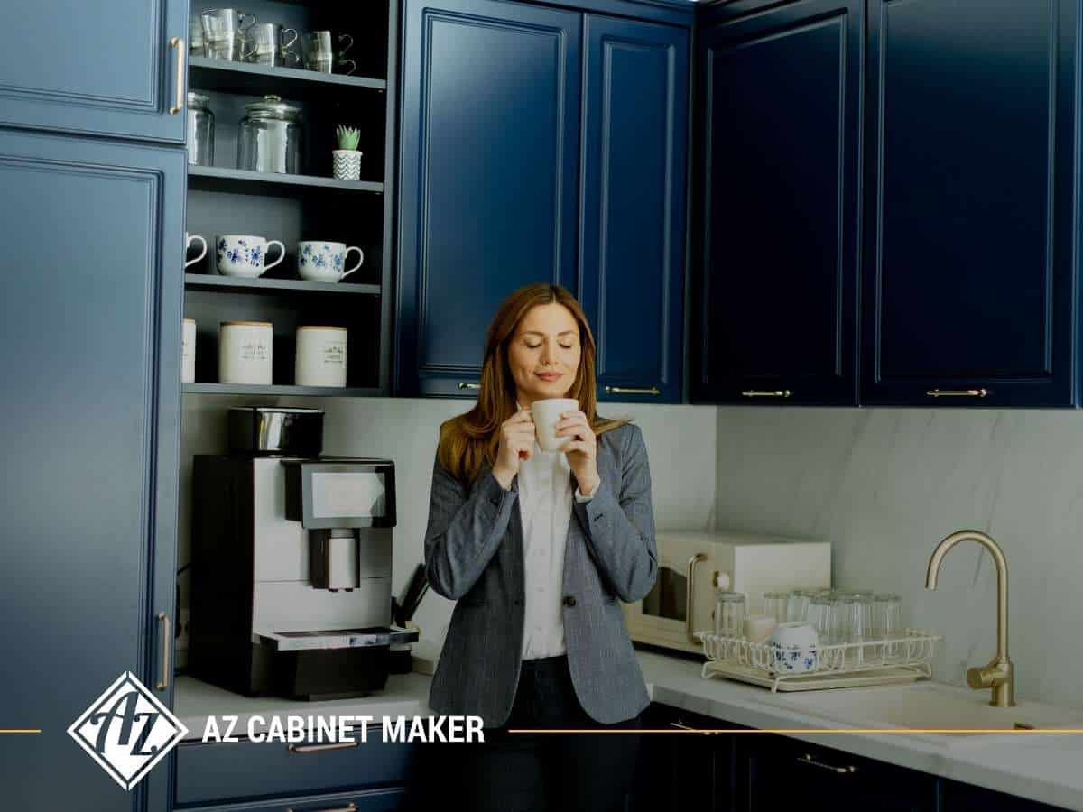 Woman enjoying coffee in a kitchen with elegant blue Custom Cabinets