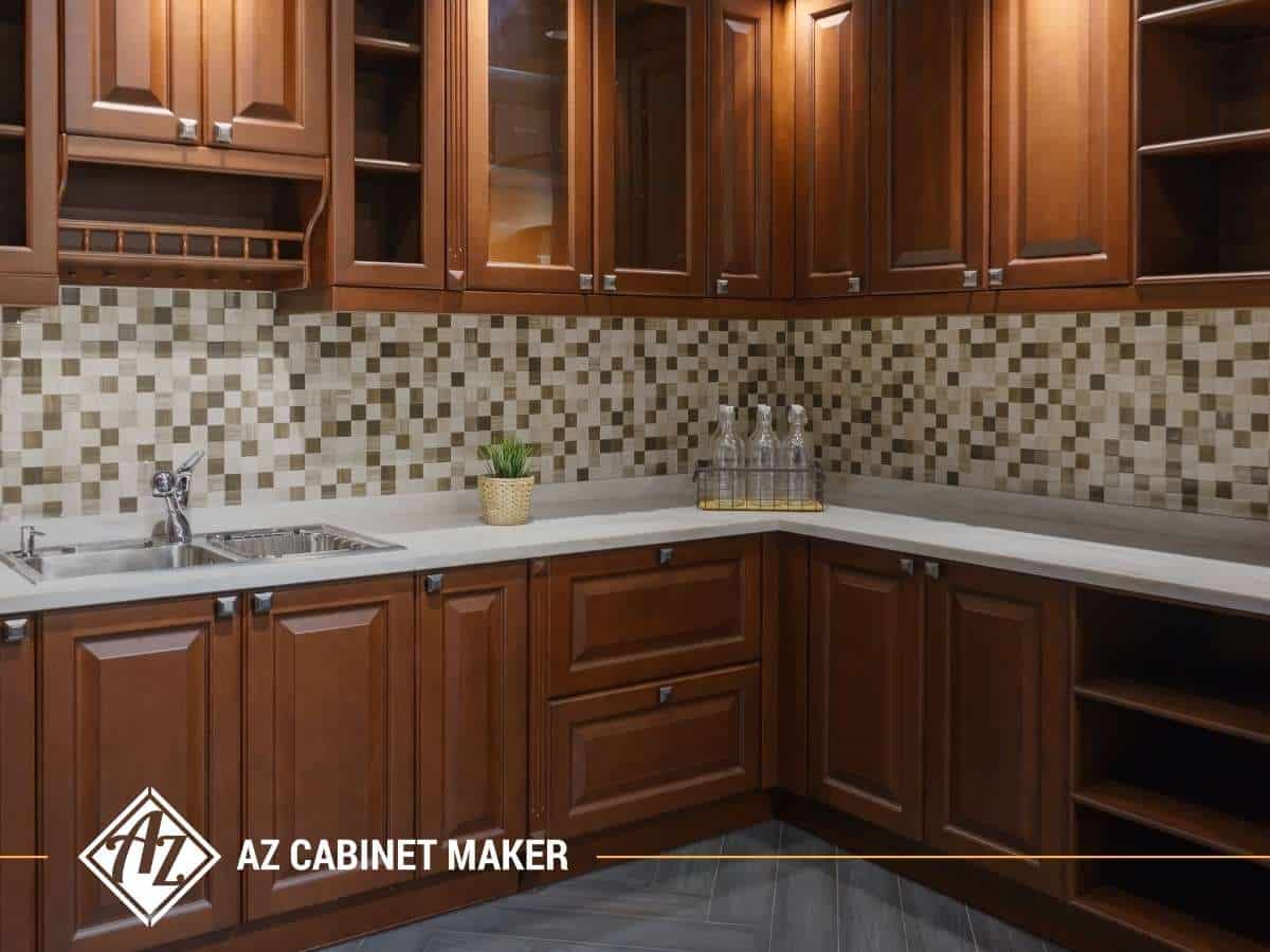 Kitchen interior featuring traditional wood cabinets with mosaic tile backsplash